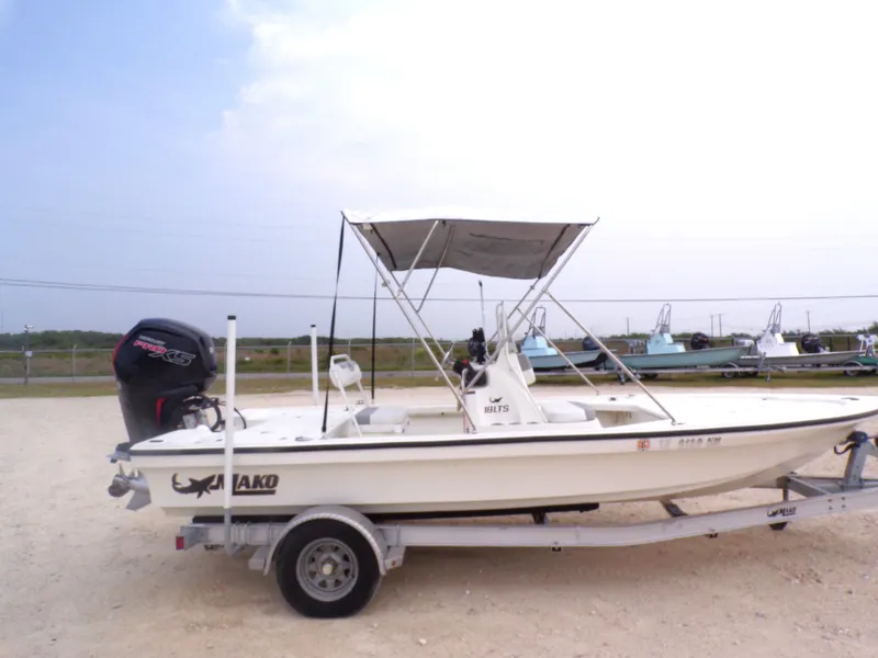 Slide: The Image of 2022 Mako 18 LTS boat on trailer outdoors. - 20