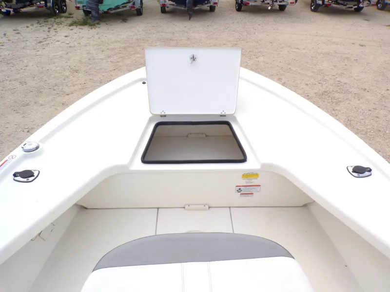 Slide: The Image of 2022 Mako 18 LTS boat with open storage compartment lid. - 26