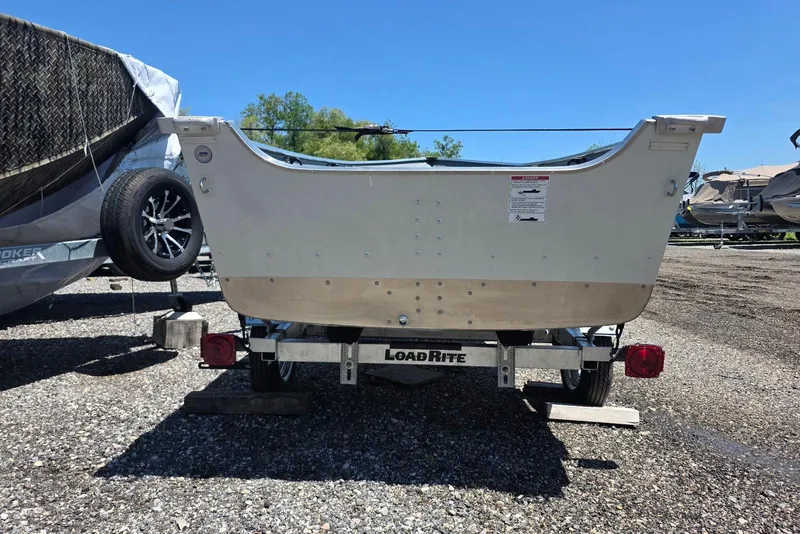 Slide: The Image of 2026 Smoker Craft Alaskan 15 TS DLX boat on Load Rite trailer, parked outdoors. - 3