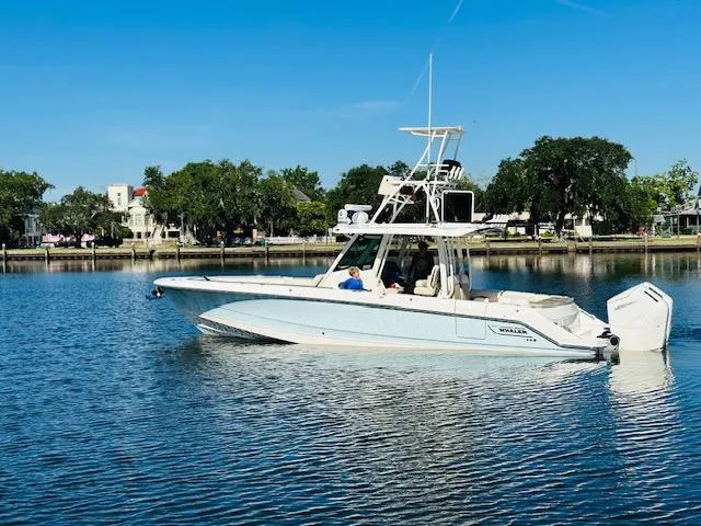 The Image of 2023 Boston Whaler 360 Outrage boat on calm water, clear sky, and scenic background. - 0