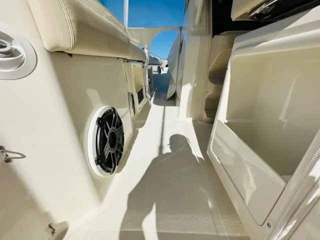 Slide: The Image of 2023 Boston Whaler 360 Outrage interior, featuring seating and storage compartments. - 18