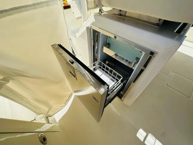 Slide: The Image of Open refrigerator drawer on 2023 Boston Whaler 360 Outrage boat. - 25