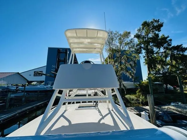 Slide: The Image of 2023 Boston Whaler 360 Outrage boat docked under clear blue sky. - 37