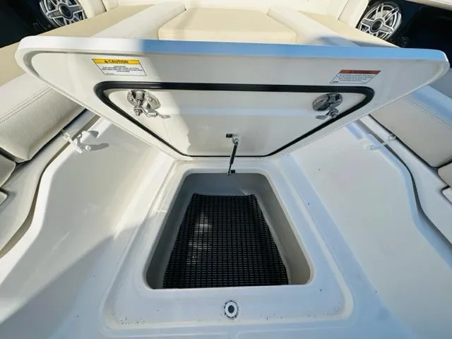 Slide: The Image of 2023 Boston Whaler 360 Outrage storage compartment with open hatch. - 38