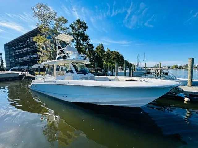 Slide: The Image of 2023 Boston Whaler 360 Outrage boat docked in a marina. - 4