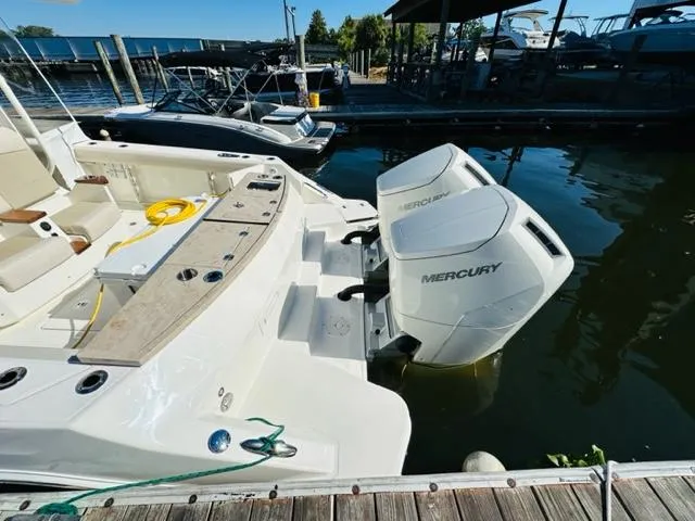 Slide: The Image of 2023 Boston Whaler 360 Outrage with twin Mercury outboard engines docked at marina. - 8
