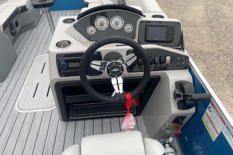 Slide: The Image of Cockpit of 2026 SunCatcher Select 322RC boat with steering wheel and control panel. - 14