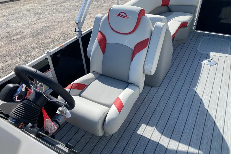 Slide: The Image of 2026 SunCatcher Select 322RC boat interior with steering wheel and cushioned seating. - 10