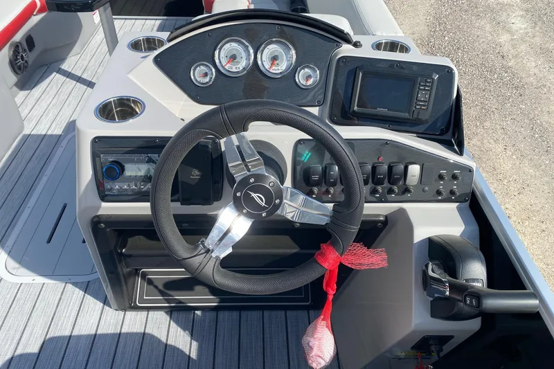 Slide: The Image of 2026 SunCatcher Select 322RC boat dashboard with steering wheel, gauges, and controls. - 11