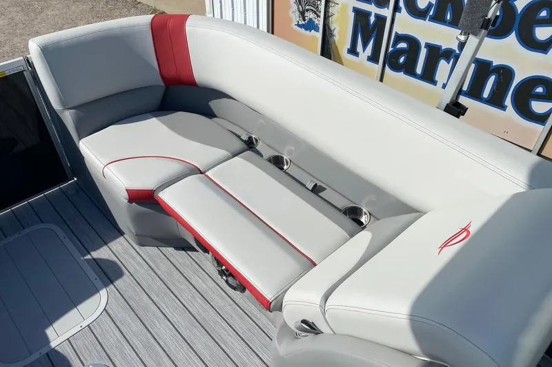 Slide: The Image of Luxurious seating on 2026 SunCatcher Select 322RC pontoon boat with red accents and cup holders. - 12