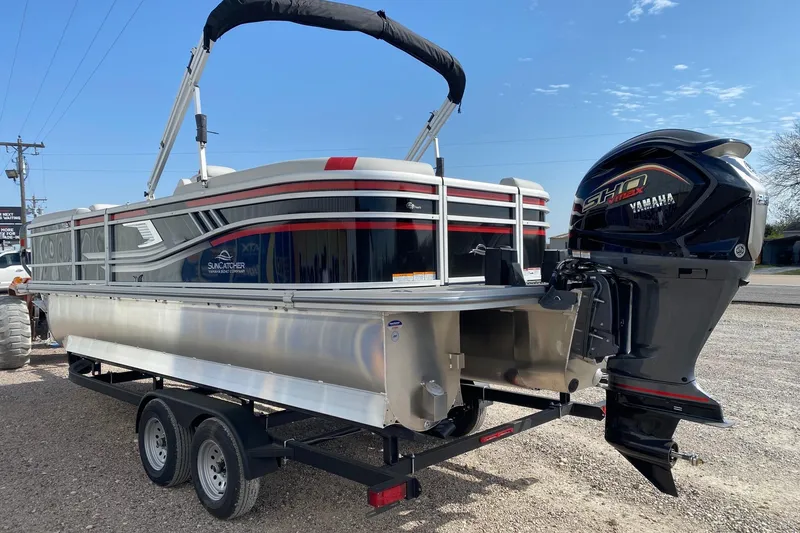 Slide: The Image of SunCatcher Select 322RC 2026 pontoon boat with Yamaha engine on trailer. - 4