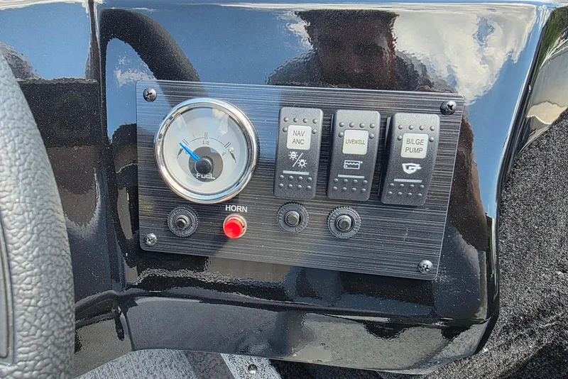 Slide: The Image of Control panel of 2026 Smoker Craft Pro Angler 165 SC boat with switches and fuel gauge. - 18