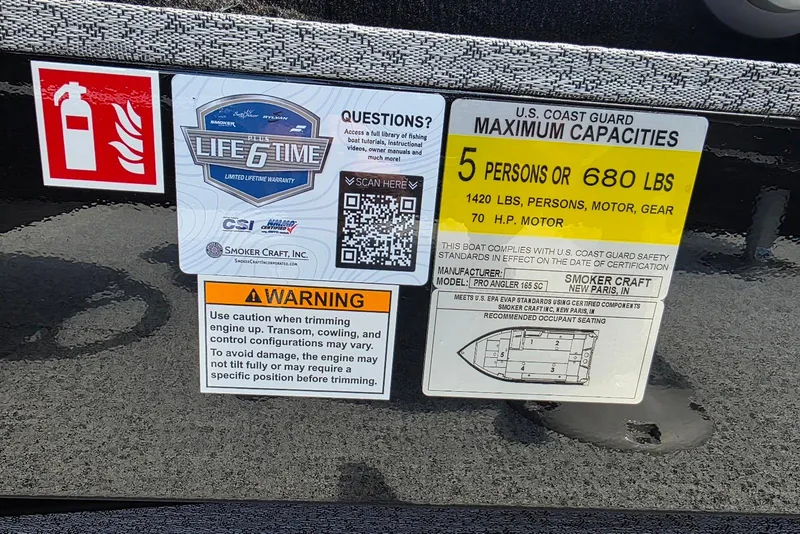 Slide: The Image of 2026 Smoker Craft Pro Angler 165 SC capacity label, safety warnings, and warranty details. - 19