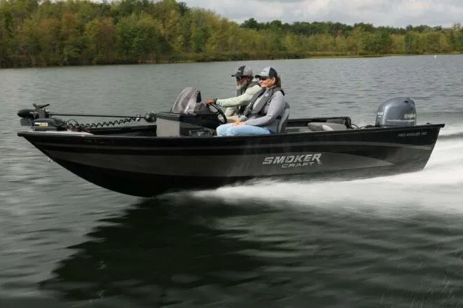 Slide: The Image of Manufacturer Provided Image: 2026 Smoker Craft Pro Angler 165 SC boat cruising on a serene lake. - 26