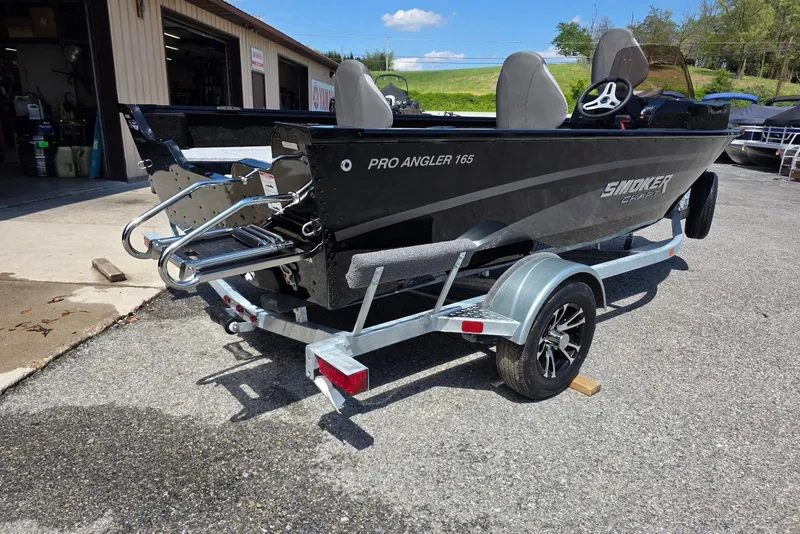 Slide: The Image of 2026 Smoker Craft Pro Angler 165 SC boat on trailer, parked outdoors. - 5
