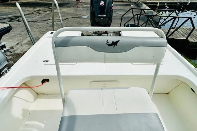 Slide: The Image of 2023 Mako 18 LTS boat interior with seating and motor view. - 13