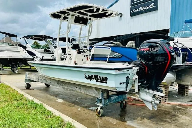 Slide: The Image of 2023 Mako 18 LTS boat with Mercury engine displayed at a dealership. - 2