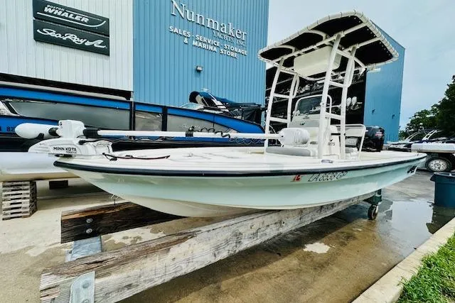Slide: The Image of 2023 Mako 18 LTS boat displayed at a marina store. - 8