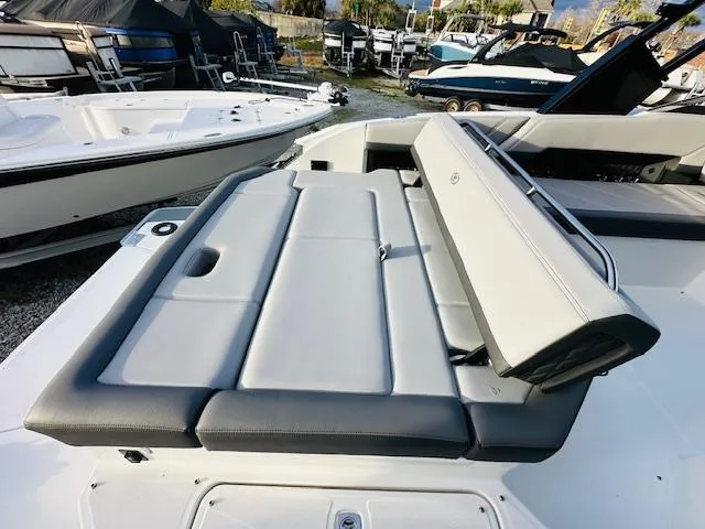 Slide: The Image of 2022 Cobalt R8 boat with sleek seating, docked among other boats. - 11