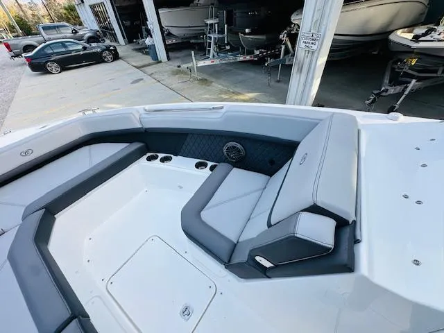Slide: The Image of 2022 Cobalt R8 boat interior with gray seating and cup holders in a storage area. - 18