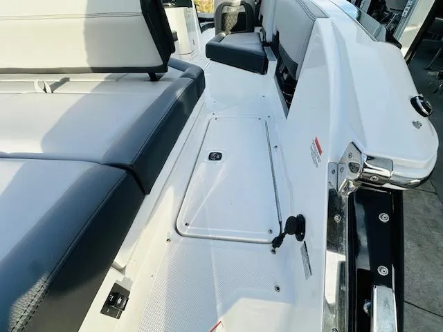Slide: The Image of 2022 Cobalt R8 boat interior with white and gray seating, storage compartment, and sleek design. - 9