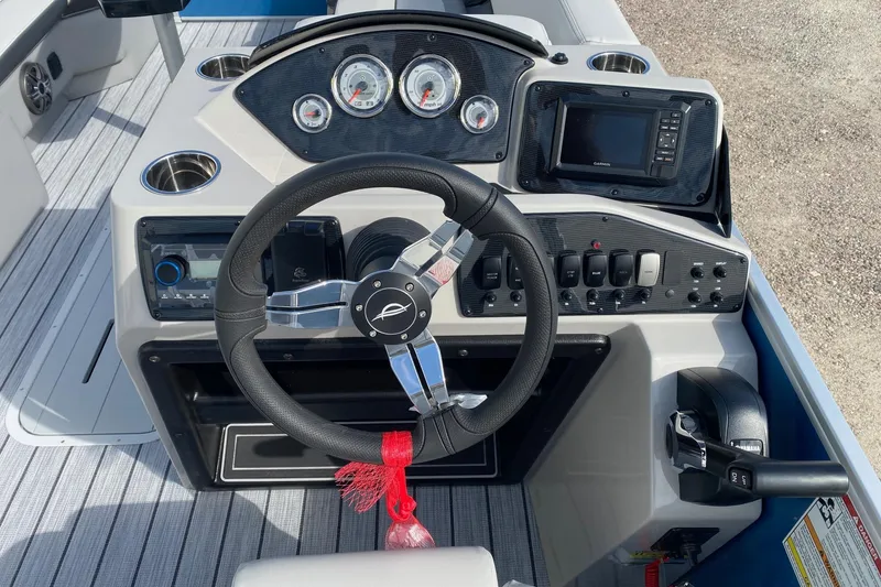 Slide: The Image of 2026 SunCatcher Select 322RC boat dashboard with steering wheel, gauges, and controls. - 10