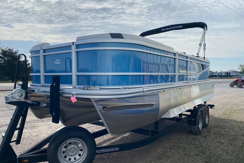 Slide: The Image of 2026 SunCatcher Select 322RC pontoon boat on trailer, blue and silver design. - 3