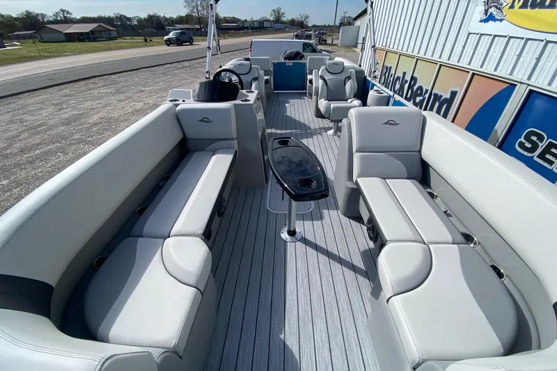 Slide: The Image of 2026 SunCatcher Select 322RC pontoon boat interior with plush seating and sleek design. - 6