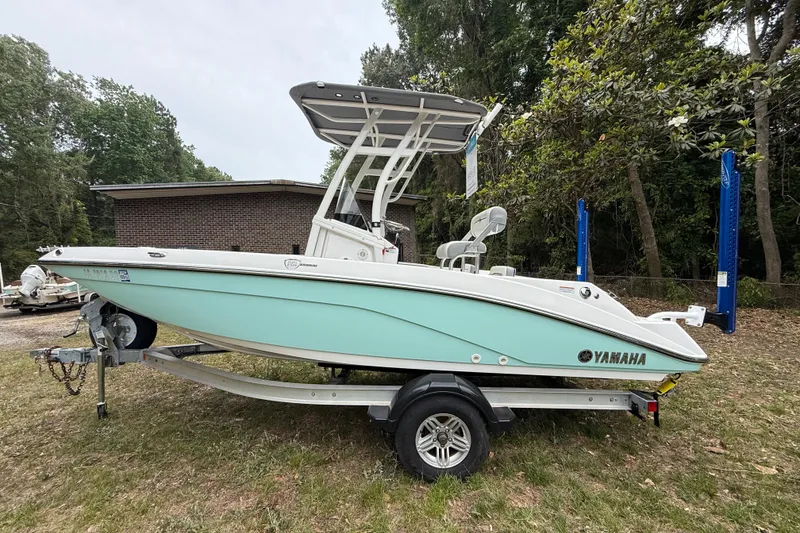 The Image of 2020 Yamaha Boats 195 FSH Sport in mint green on trailer, parked outdoors. - 1