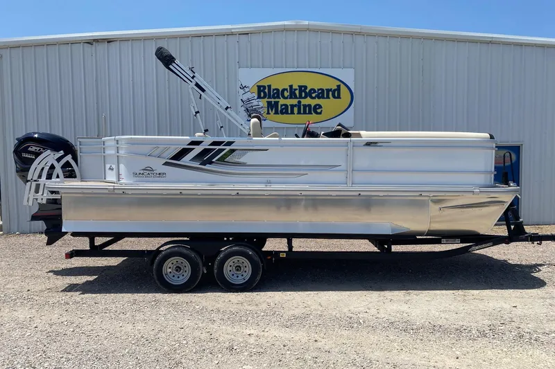 The Image of 2026 SunCatcher Select 322RF pontoon boat on trailer at BlackBeard Marine dealership. - 1