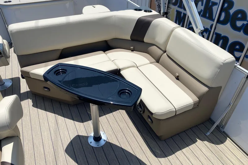 Slide: The Image of Luxurious seating area on 2026 SunCatcher Select 322RF pontoon boat with sleek table design. - 10