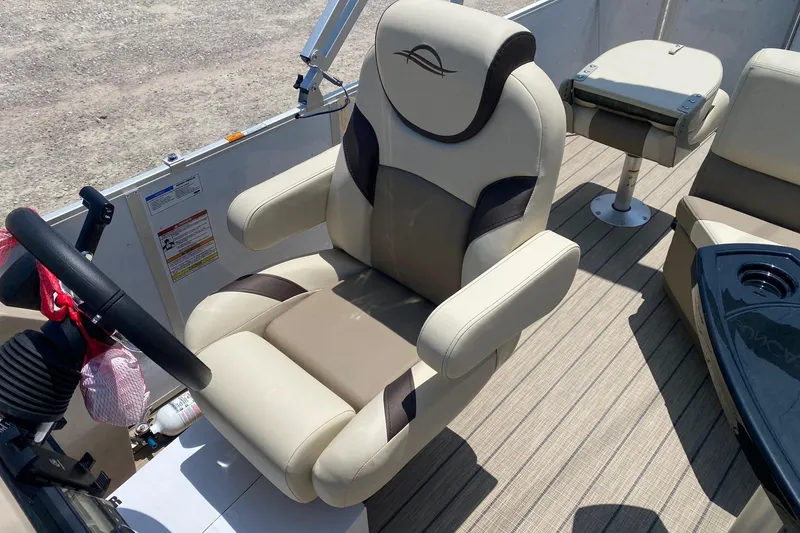 Slide: The Image of Captain's chair on 2026 SunCatcher Select 322RF boat, featuring beige and brown upholstery. - 12