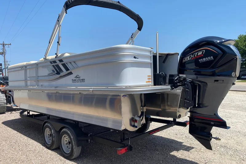 Slide: The Image of 2026 SunCatcher Select 322RF pontoon boat with Yamaha outboard motor on trailer. - 4