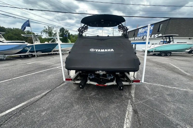 Slide: The Image of 2023 Yamaha Boats 222XD covered on trailer at dealership lot. - 11
