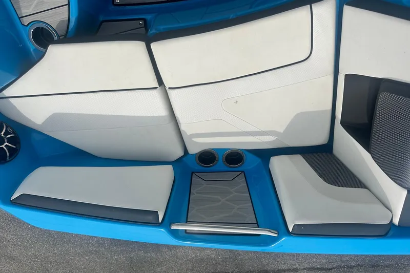 Slide: The Image of 2023 Yamaha Boats 222XD interior seating with blue and white upholstery. - 22