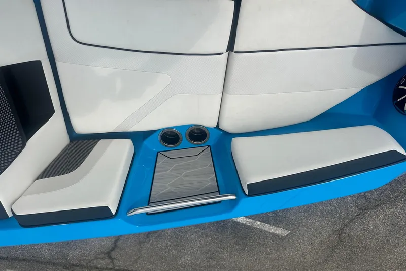 Slide: The Image of Interior seating of 2023 Yamaha Boats 222XD, featuring sleek white and blue design. - 23