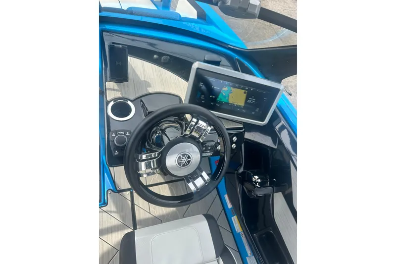 Slide: The Image of 2023 Yamaha Boats 222XD cockpit with steering wheel and touchscreen display. - 27