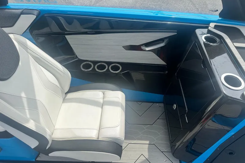 Slide: The Image of 2023 Yamaha Boats 222XD interior with white seating and sleek black console design. - 32