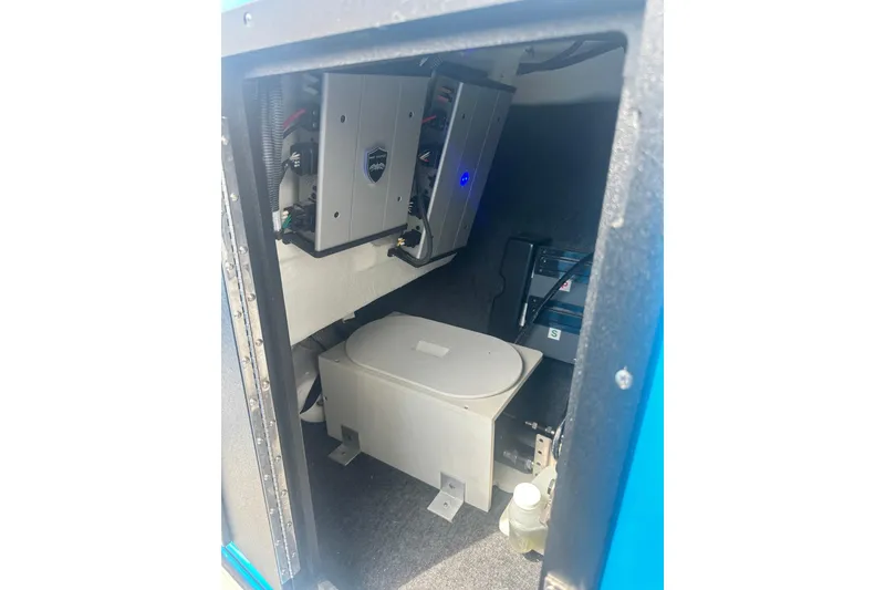 Slide: The Image of Interior view of 2023 Yamaha Boats 222XD, showcasing electrical components and storage area. - 34