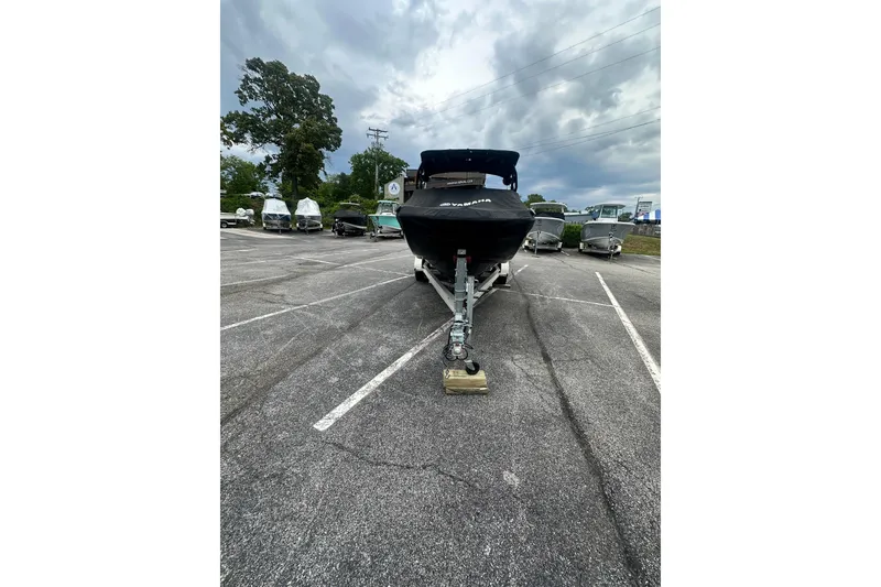 Slide: The Image of 2023 Yamaha Boats 222XD on trailer in parking lot under cloudy sky. - 5