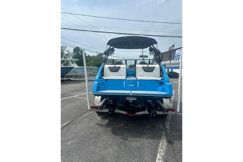 Slide: The Image of 2023 Yamaha Boats 222XD in blue, rear view, parked on a trailer. - 6