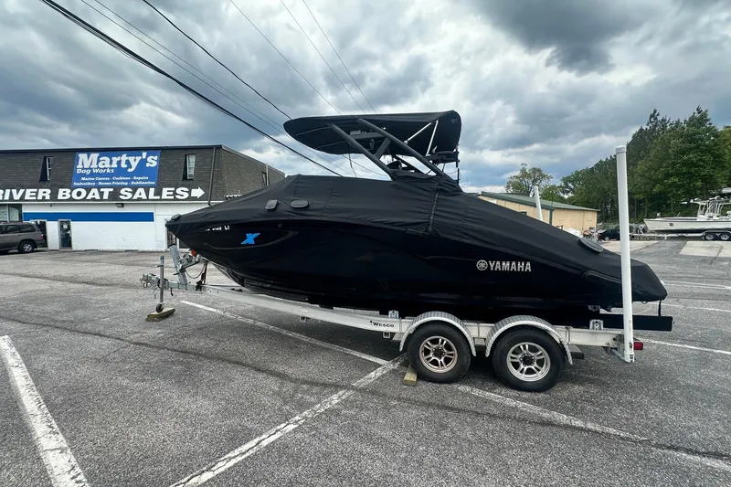 Slide: The Image of 2023 Yamaha Boats 222XD covered on trailer at boat sales lot. - 9