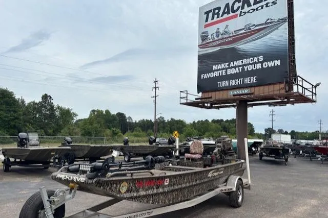 The Image of Pro-Drive X SERIES TD EDITION 1854 boat, 2022 model, parked near Tracker Boats billboard. - 1