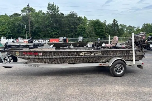 Slide: The Image of 2022 Pro-Drive X SERIES TD EDITION 1854 boat on trailer, parked outdoors. - 3