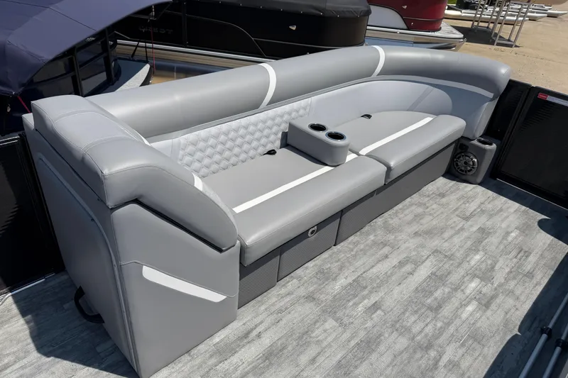 Slide: The Image of 2023 Crest Classic DLX 240 SLC boat interior with gray seating and cup holders. - 11