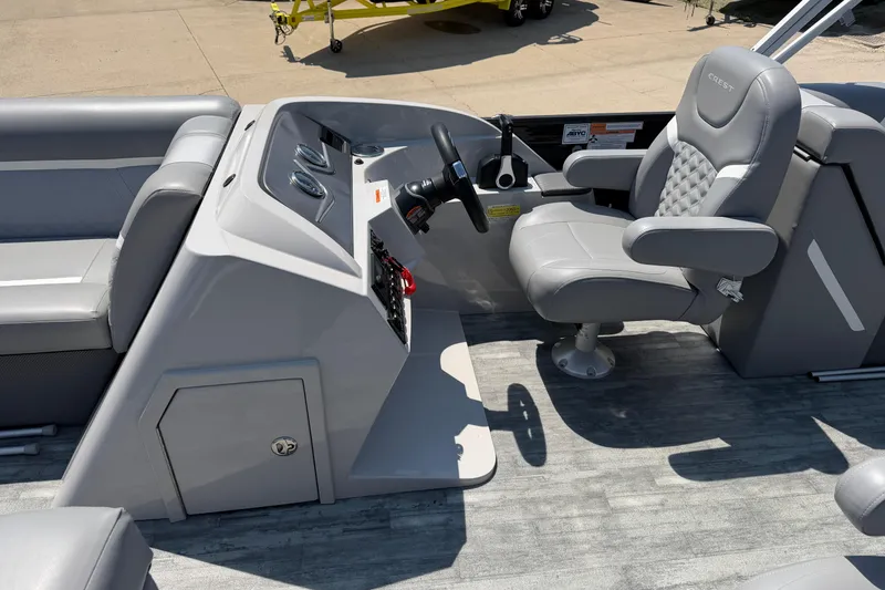 Slide: The Image of 2023 Crest Classic DLX 240 SLC boat interior with steering console and captain's chair. - 15