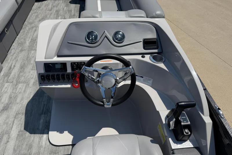 Slide: The Image of 2023 Crest Classic DLX 240 SLC boat helm with modern controls and steering wheel. - 17