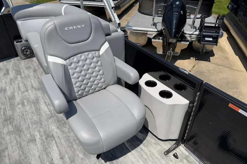 Slide: The Image of 2023 Crest Classic DLX 240 SLC boat seat with cup holders and sleek design. - 18