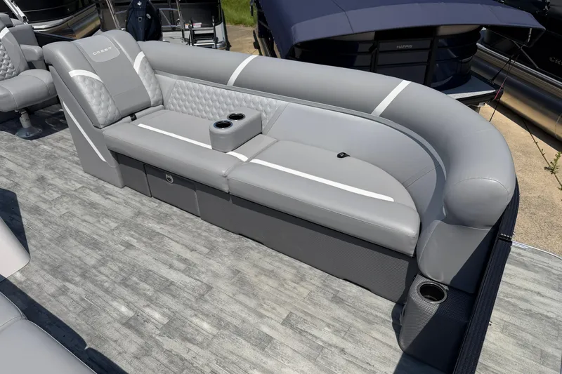Slide: The Image of 2023 Crest Classic DLX 240 SLC pontoon boat with luxurious gray seating and cup holders. - 6