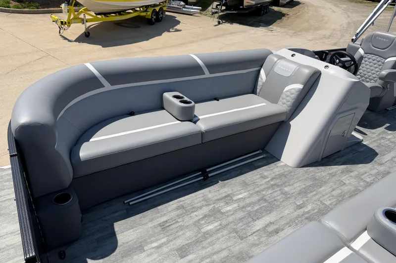 Slide: The Image of 2023 Crest Classic DLX 240 SLC pontoon boat interior with gray seating and cup holders. - 8